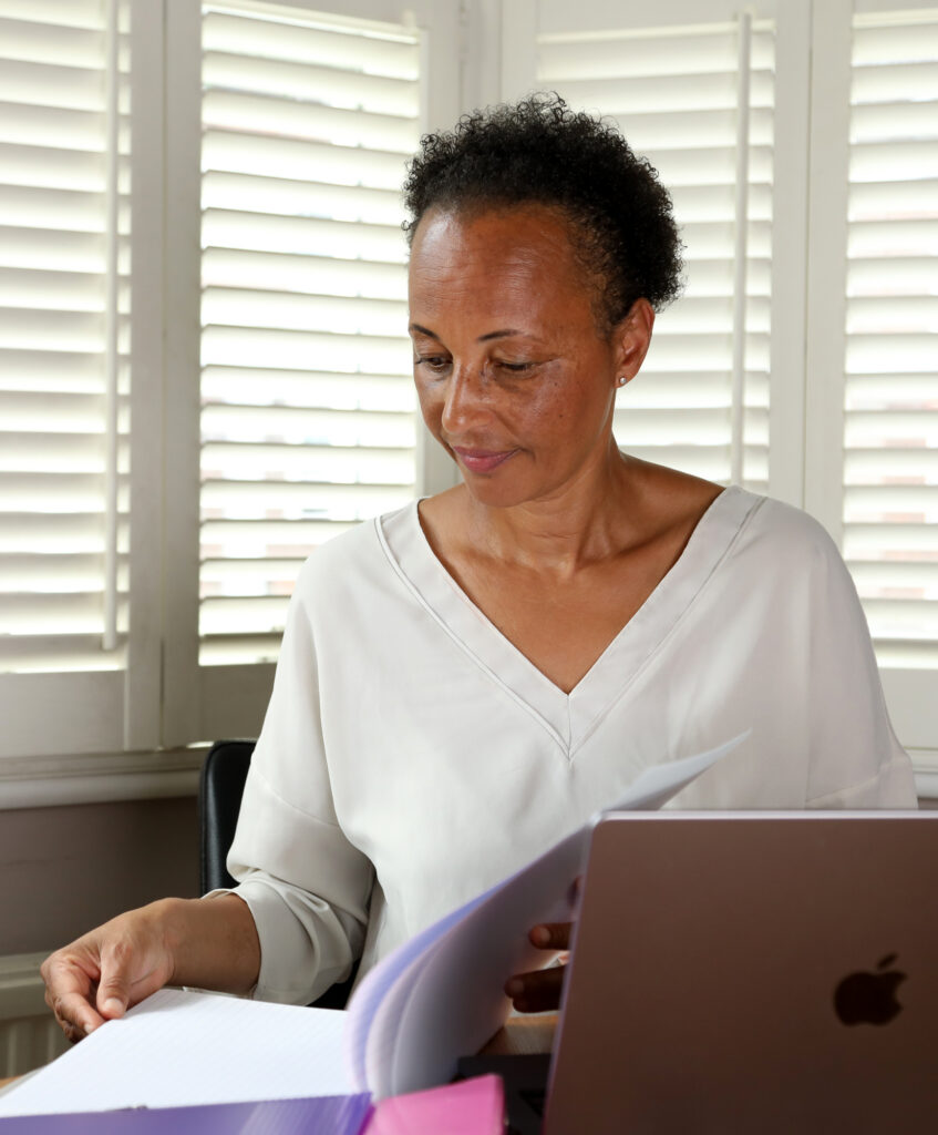 Corinne Delacour career confidence coach London looking at a file